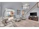 Elegant living room with staircase and view to the kitchen at 9834 Belcrest Ln, Indianapolis, IN 46256