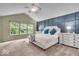 Main bedroom featuring a vaulted ceiling, neutral carpet, and large windows at 9834 Belcrest Ln, Indianapolis, IN 46256