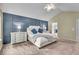 Bright main bedroom features a gray paneled accent wall and neutral colored carpet at 9834 Belcrest Ln, Indianapolis, IN 46256