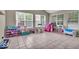 Spacious playroom filled with natural light, tile flooring and room for  at 9834 Belcrest Ln, Indianapolis, IN 46256