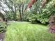 Spacious backyard features a well-kept lawn, mature trees, and brick home exterior at 10130 Central Ave, Carmel, IN 46280
