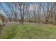Spacious backyard with well-maintained lawn and privacy from mature trees. Features wooded area at property's edge at 10130 Central Ave, Carmel, IN 46280