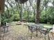 A backyard brick patio with outdoor seating offers a relaxing retreat at 10130 Central Ave, Carmel, IN 46280