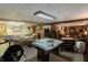 Versatile basement with exercise equipment, craft space, and seating area, offering options for recreation and hobbies at 10130 Central Ave, Carmel, IN 46280