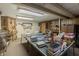 Spacious basement featuring a ping pong table covered with craft supplies and surrounded by storage and decor at 10130 Central Ave, Carmel, IN 46280