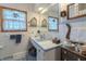 Well-lit bathroom featuring a charming tile countertop and decorative accents for a cozy and inviting atmosphere at 10130 Central Ave, Carmel, IN 46280