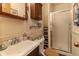 Bathroom featuring white tiling, a glass shower door, and a vintage vanity with ample storage at 10130 Central Ave, Carmel, IN 46280