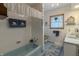 Bathroom featuring a bathtub, tiled walls, and a well-lit vanity, offering a clean and functional space at 10130 Central Ave, Carmel, IN 46280