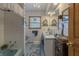 Bathroom featuring blue tiled walls, a bathtub, and a vanity with ample storage for a refreshing experience at 10130 Central Ave, Carmel, IN 46280