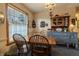 Charming dining room features a wooden table set, decorative hutch, and natural light from the window at 10130 Central Ave, Carmel, IN 46280