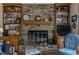 Living room featuring a brick fireplace with built-in shelving and decorative elements at 10130 Central Ave, Carmel, IN 46280