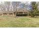 Lovely single-story brick home featuring a well-kept lawn, mature trees, and inviting curb appeal at 10130 Central Ave, Carmel, IN 46280