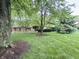 Charming single-story home with well-manicured front yard and mature trees at 10130 Central Ave, Carmel, IN 46280