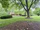 Well-maintained front lawn and mature trees provide a peaceful setting at 10130 Central Ave, Carmel, IN 46280