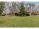 Attractive single-story brick home with a well-maintained lawn and mature trees in a serene environment at 10130 Central Ave, Carmel, IN 46280