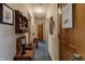 Hallway with blue carpet, wooden doors, and decorative furnishings for a cozy and welcoming atmosphere at 10130 Central Ave, Carmel, IN 46280