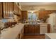 Spacious kitchen featuring wood cabinets, laminate countertops, and a bright window over the sink at 10130 Central Ave, Carmel, IN 46280