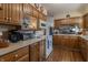 Well-equipped kitchen features wood cabinetry, laminate counters, and a view to living room at 10130 Central Ave, Carmel, IN 46280