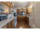 Functional kitchen with wooden cabinets, laminate countertops, and a view into the living area at 10130 Central Ave, Carmel, IN 46280