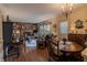 Inviting living room with a brick fireplace, comfortable seating, and adjoining breakfast nook at 10130 Central Ave, Carmel, IN 46280