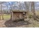 Wooden shed with a double-door design, windows with flower boxes, and a vintage lantern, adding charm to the yard at 10130 Central Ave, Carmel, IN 46280