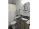 Cozy bathroom featuring a granite countertop vanity, modern mirror, and a shower-tub combo at 10421 Sand Creek Blvd, Fishers, IN 46037