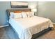 Queen-sized bed with decorative pillows and a stylish headboard is the focus of this comfortable bedroom at 10421 Sand Creek Blvd, Fishers, IN 46037