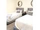 Shared bedroom featuring twin beds, neutral tones, and bedside table at 10421 Sand Creek Blvd, Fishers, IN 46037