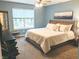 Comfortable bedroom with a large window, plush carpet, and a queen-sized bed with stylish furnishings at 10421 Sand Creek Blvd, Fishers, IN 46037