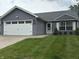 Charming single-story home with gray siding, attached garage, and well-maintained lawn at 10421 Sand Creek Blvd, Fishers, IN 46037