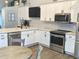 Kitchen boasts white cabinets, granite countertops, stainless steel appliances, and a stylish backsplash at 10421 Sand Creek Blvd, Fishers, IN 46037