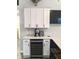 Well-lit kitchen with white cabinets, modern appliances, granite countertops, and a backsplash at 10421 Sand Creek Blvd, Fishers, IN 46037
