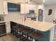 Modern kitchen featuring white cabinets, stainless steel appliances, and a large island with bar seating at 10421 Sand Creek Blvd, Fishers, IN 46037