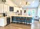 Modern kitchen featuring white cabinetry, a central island with bar stools, and stainless steel appliances at 10421 Sand Creek Blvd, Fishers, IN 46037