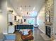 An open layout connects the kitchen with the living area with vaulted ceilings at 10421 Sand Creek Blvd, Fishers, IN 46037