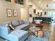 Open-concept living room with modern furnishings, hardwood floors, and ample natural light at 10421 Sand Creek Blvd, Fishers, IN 46037