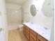 Spacious bathroom featuring a double vanity, bathtub and matching framed mirrors at 10501 Morning Song Dr, Fishers, IN 46038