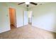 Bright bedroom with carpeted floors, closet and open door to hallway at 10501 Morning Song Dr, Fishers, IN 46038