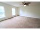 This spacious bedroom offers two windows for natural light and a ceiling fan at 10501 Morning Song Dr, Fishers, IN 46038