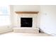 Bright living room featuring stone fireplace with a wooden mantel at 10501 Morning Song Dr, Fishers, IN 46038
