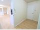 Hallway features hardwood floors, neutral walls, and an adjacent view to the kitchen at 10501 Morning Song Dr, Fishers, IN 46038