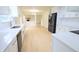 Contemporary kitchen featuring white cabinetry, stainless steel appliances and an eat-in breakfast bar at 10501 Morning Song Dr, Fishers, IN 46038