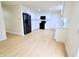 Modern kitchen featuring stainless steel appliances, white cabinets and hardwood floors at 10501 Morning Song Dr, Fishers, IN 46038