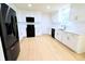 A well-equipped kitchen featuring stainless steel appliances, white cabinets, and a large window above the sink at 10501 Morning Song Dr, Fishers, IN 46038