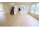Open living room with hardwood floors, a staircase, and large windows that let in natural light at 10501 Morning Song Dr, Fishers, IN 46038