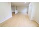 An open living room with wood floors and neutral walls at 10501 Morning Song Dr, Fishers, IN 46038