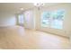Bright living room with hardwood floors, ample natural light and modern chandelier at 10501 Morning Song Dr, Fishers, IN 46038