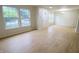 An open living room with wood floors, neutral walls, and large windows at 10501 Morning Song Dr, Fishers, IN 46038