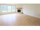 Spacious living room featuring wood floors, fireplace, and large windows at 10501 Morning Song Dr, Fishers, IN 46038