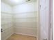 Walk-in closet featuring wooden floors, shelving, and overhead lighting at 10501 Morning Song Dr, Fishers, IN 46038